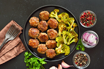 Homemade cutlets and fried broccoli on plate