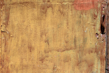 Old metal painted yellow-orange surface.