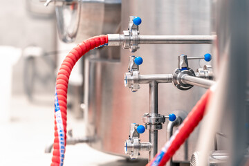 stainless steel boilers and vessels with pipes for brewing beer in a brewery