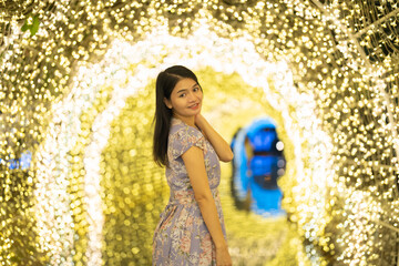 Portrait of happy Asian woman with bokeh blurry background for lighting festive celebration concept. illumination. People lifestyle.