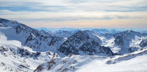 Fototapeta na wymiar Panoramic view of Alps mountain snowy range with skiing trails, Stubai Glacier