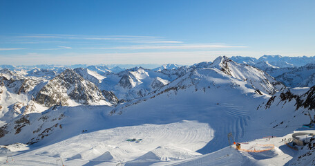 Fototapeta na wymiar Panoramic view of Alps mountain snowy range with skiing trails, Stubai Glacier