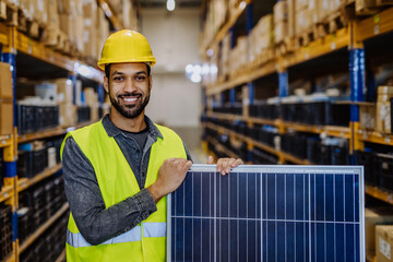 Portrait of warehouse worker with solar panel.