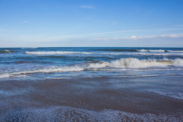  high waves on the blue beach with blue sky