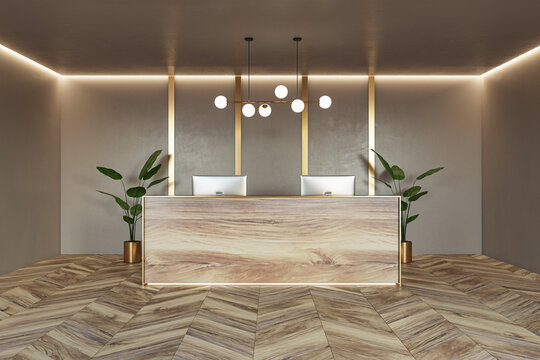 Front view on stylish reception desk made from natural wooden slab with modern computers on parquet floor with green plants on beige wall background with lightning on top. 3D rendering