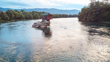 Fototapeta na wymiar Small wooden cabin on a rock in the middle of river Drina, Serbia..