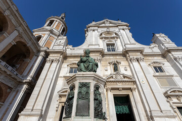 LORETO, ITALY, JULY 5, 2022 - View of the facade of Shrine of the Holy House of Loreto with Pope Sixtus V's Monument in Loreto, Italy