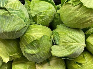 Grocery store green cabbage on display produce department