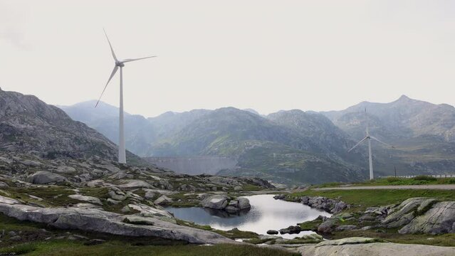 Scenic view of wind turbines on a mountain pass. Windmill in scenic settings, sustainability in nature