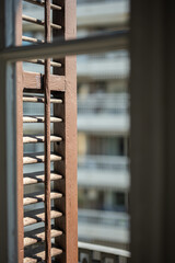 Close-up of typical spanish shutters on the windows on a sunny warm summer day. Concept of beauty and traditional technologies in construction and design