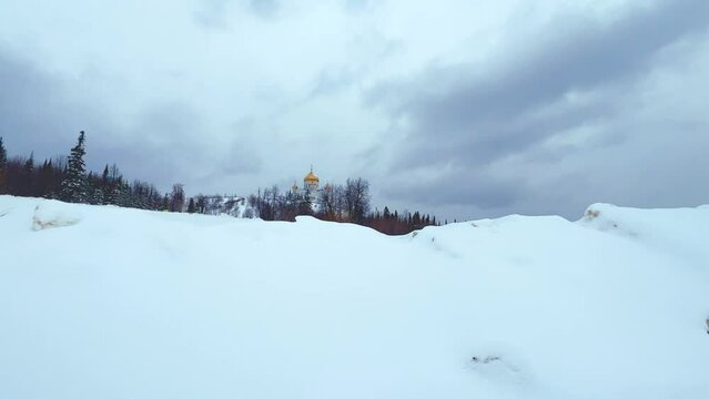 Belogorsky St. Nicholas Orthodox Missionary Monastery. Russia, Perm Krai, Belaya Gora. The temple on the hill in winter. Monastery on the background of snow.