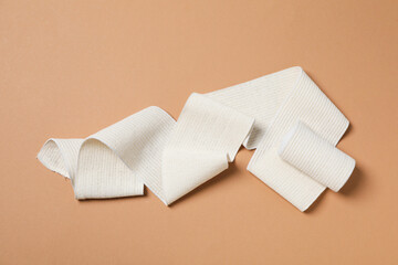 Help during an injury, elastic bandage on beige background