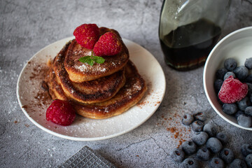 Pancakes with berries. breakfast. On a concrete background