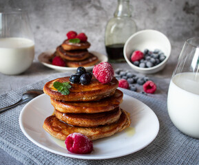 Pancakes with berries. breakfast. On a concrete background