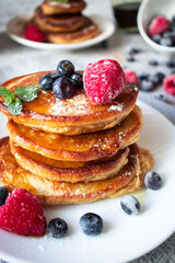 Pancakes with berries. breakfast. On a concrete background