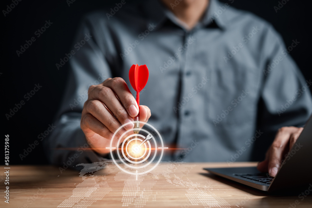 Leinwandbilder Businessman aiming red arrow dart to business target strategy dartboard for business investment planning development leadership and customer target group...