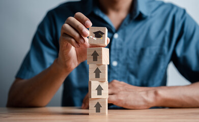 Steps of education leading to success goal. Taking strategic steps towards graduation. Career path and first for business, Graduation achievement goals concept. Graduation cap on wooden block.