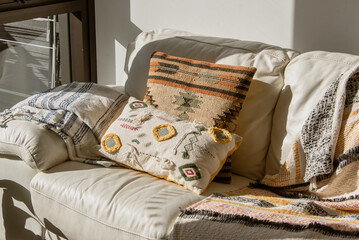 Homey living room in Sydney Apartment, couch, patterned pillowcase, sun-drenched morning, interior