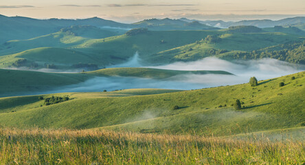 Morning light and spring greenery of hills and mountain slopes