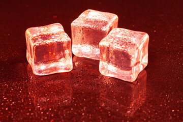 Red ice cubes on black background.