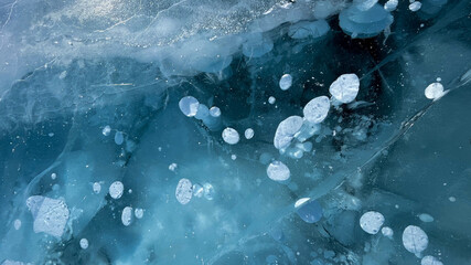 Abstract air bubbles frozen on the ice surface of Lake Baikal in Siberia.