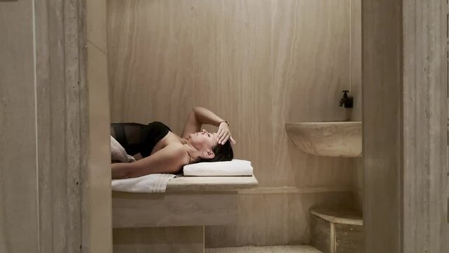 Woman Relax in a Turkish Hammam Bathroom in Switzerland.