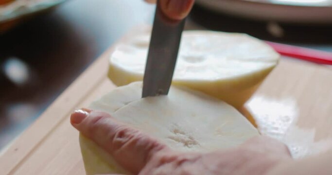 hollowing out peeled celery with a knife