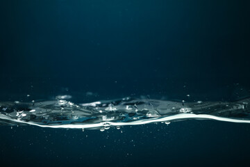 Water in aquarium against dark blue background