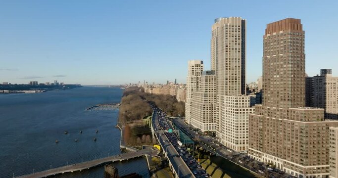 Aerial view flying along the coast of Hudson river, spring day in Upper West Side of Manhattan, NY, USA