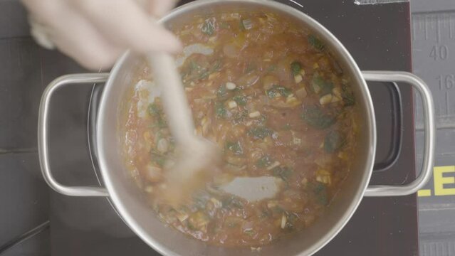 The cook mixes the ingredients for lunch. Culinary footage.