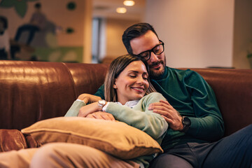 Obraz premium Two lovers taking a nap on the couch, looking happy.