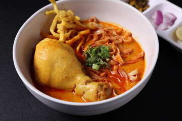 Khao Soi Thai Curry soup isolated in black background