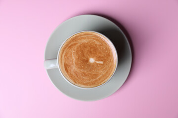 hot cappuccino with latte art isolated in pink background