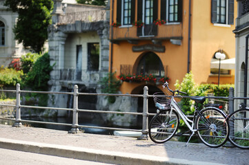 Fototapeta premium Bicycle parked on old cobblestone street in Como town, Lake Como, Italy, Europe