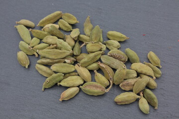 cardamom seeds on dark slate