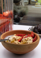 Breakfast - Healthy breakfast with oats, nuts, honey, yoghurt, raisins, 