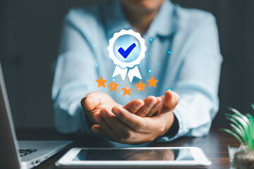 Businesswoman holding and showing best quality assurance with five stars for guarantee product and...