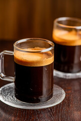 Espresso. Fresh cup of dark French roast shot of espresso with steamed milk. Classic American. French bistro, coffee house or café beverage. Typical drink served at breakfast. 
