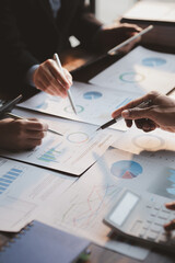 Group business people are brainstorming together and reviewing the company financial documents that the finance department has summarized, they are business partners. Business administration concept.
