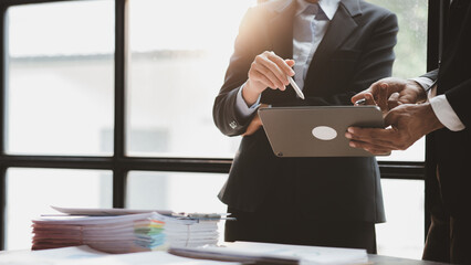 Group business people are reviewing monthly sales documents analysis and marketing plans for more sales growth, they are the founders of young companies co-founding startups. Sales management concept.