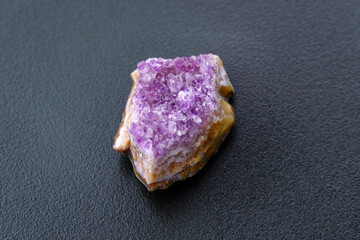 Crystal stone is a mineral. Purple rough amethyst quartz crystals, on black background