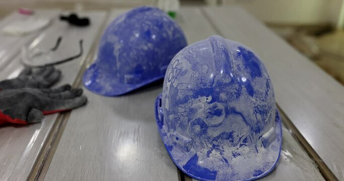 Dusty blue construction helmets at construction site closeup