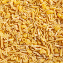 Different types and shapes of Italian pasta background