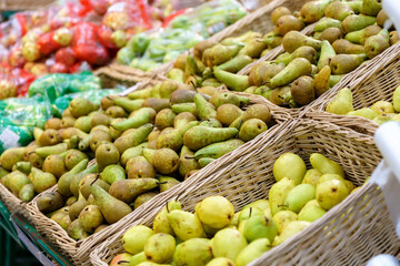 Shelves with natural fruits pears in supermarket or farmer market. Fresh food. Selective focus