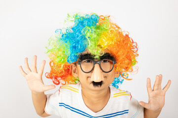 April Fool's Day. Two brothers funny kid boy clown wears curly wig colorful big nos and glasses and has mustache playing fool isolated on white background with copy space, Happy child festive decor