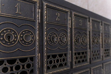 Antique letter boxes. Copper mailboxes in the post office. Vintage mailboxes. Old retro cells made of metal