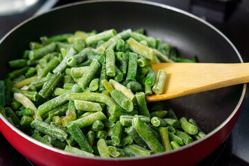 Green beans ready for cooking in frying pan. Bio green beans. Cooking concept
