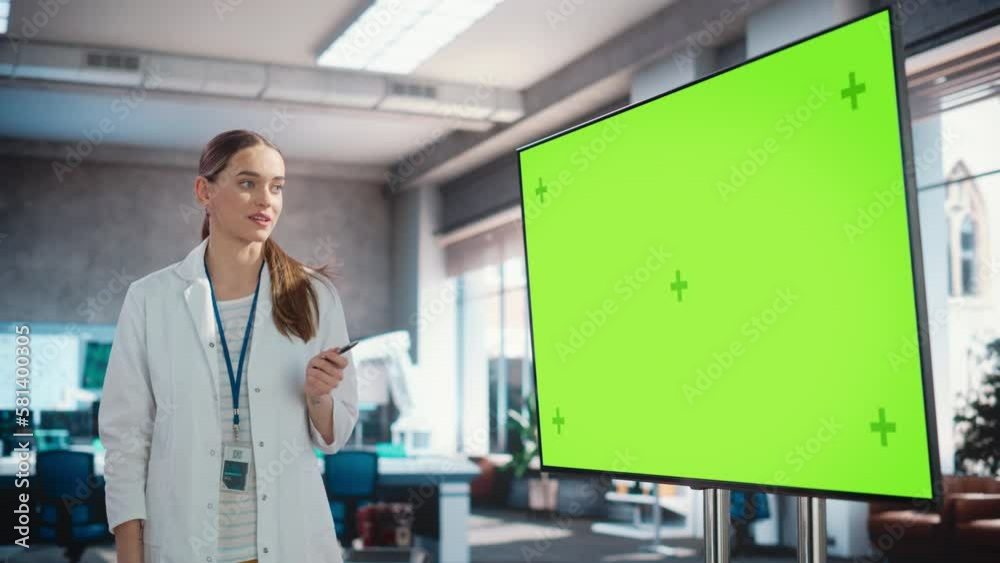 Poster excited young female specialist doing a presentation, using green screen monitor and talking to her 