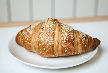 Crispy and delicious croissant with ham and cheese. Delicious breakfast
