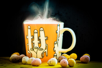 cup of coffee with tea with steam and easter eggs